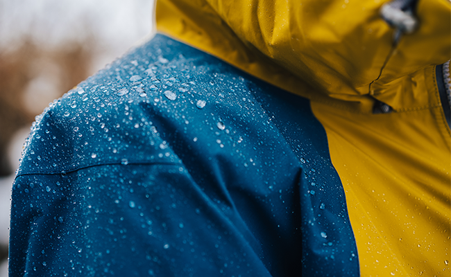 Raindrops on blue and yellow rain jacket